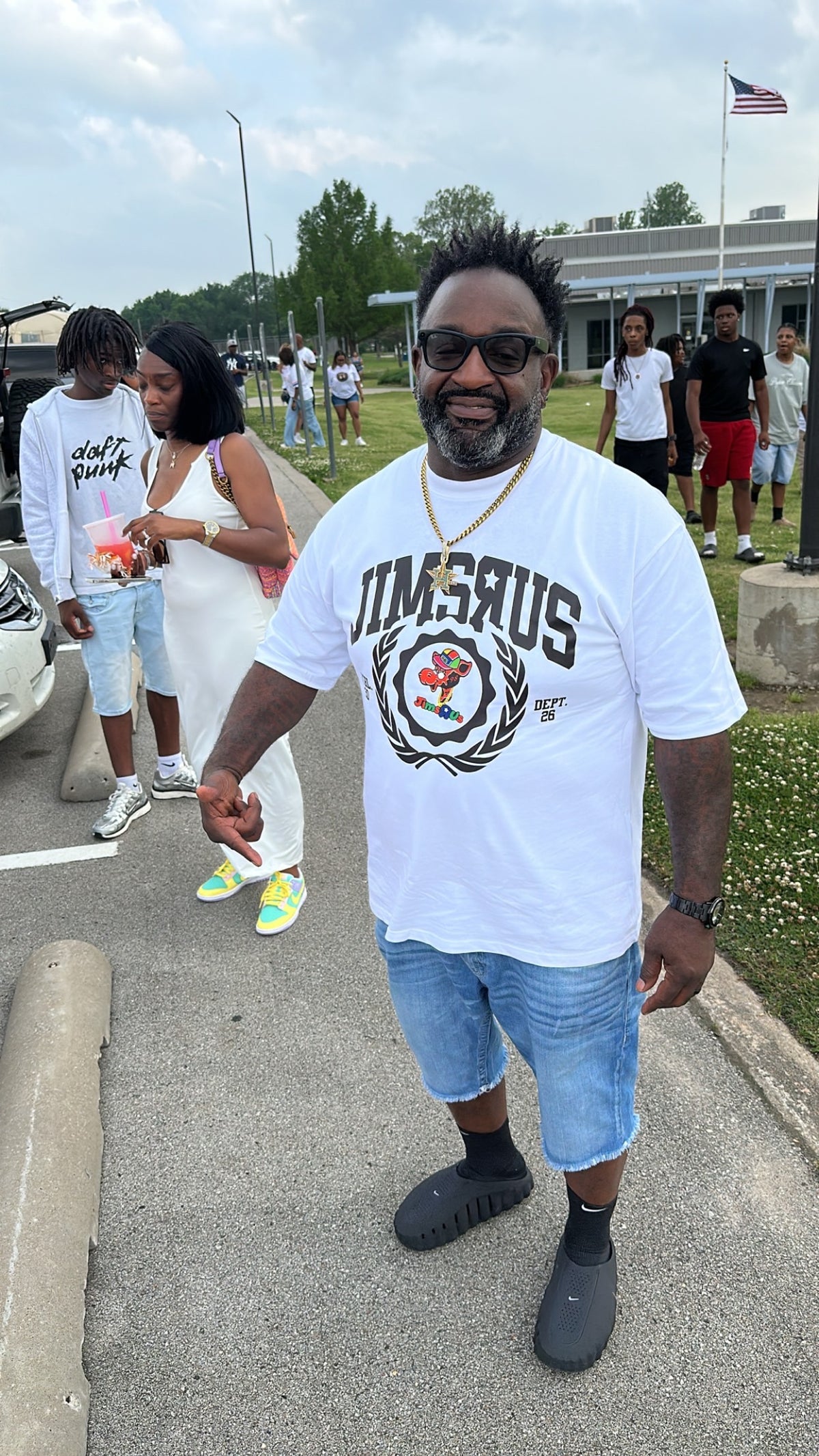 JIMSRUS customer wearing a white university crest tee