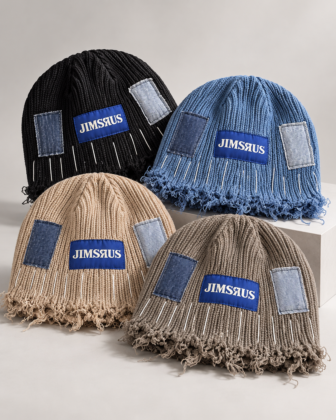 Four JIMSRUS reconstructed distressed beanies styled together in Black, Blue, Army Green, and Camel
